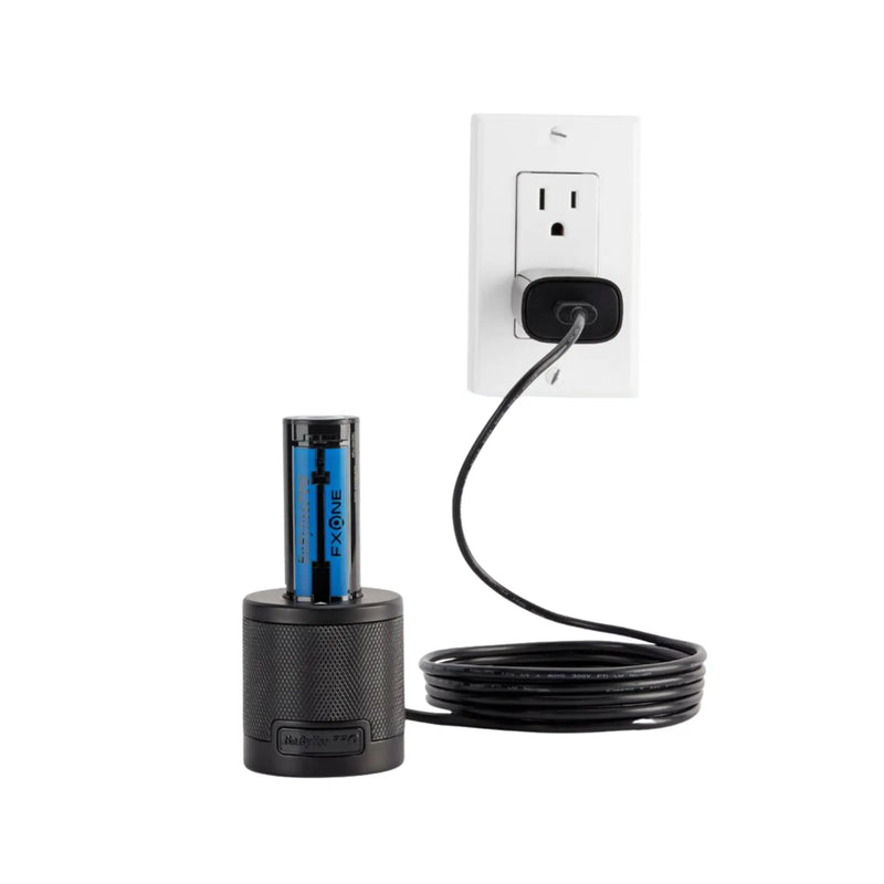 Black cylindrical device with blue label plugged into a wall outlet on a white background