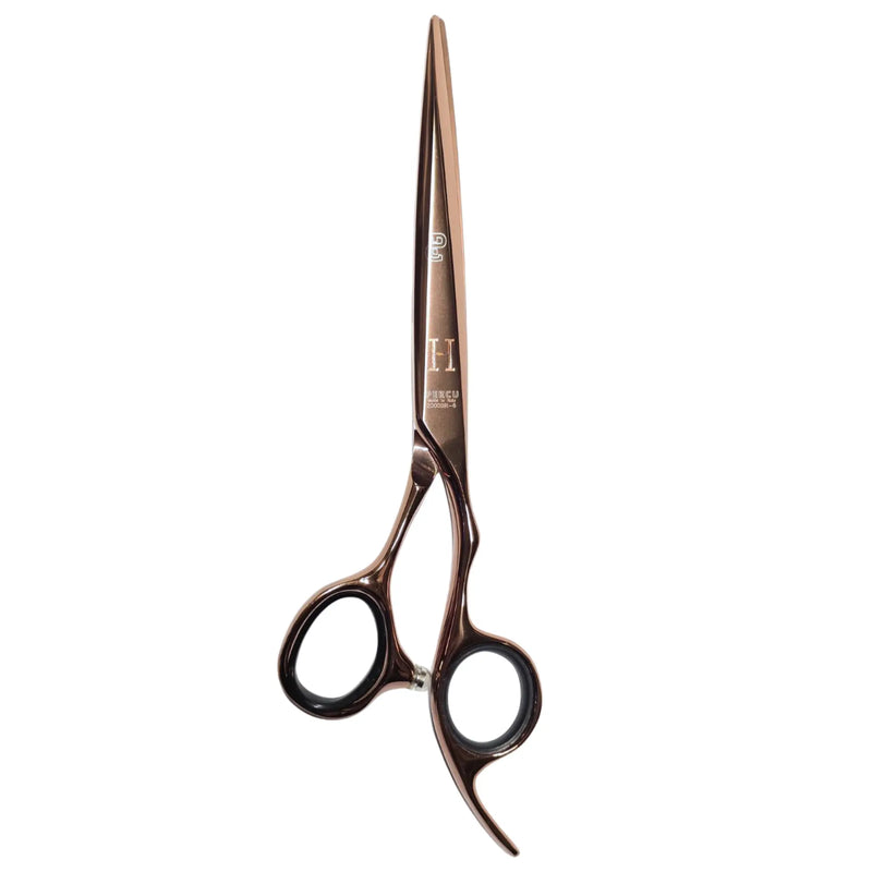 A pair of professional hairdressing shears with a metallic rose gold finish and black finger rings, shown against a plain white background.
