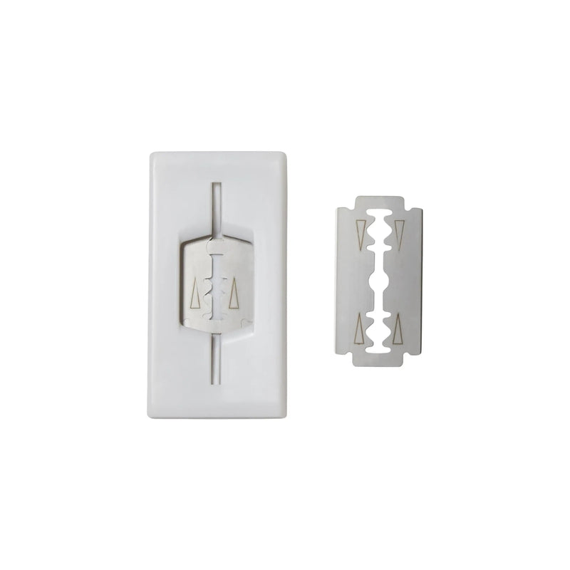 Shaving cream container with a razor blade on a white background