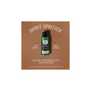 Green body spray bottle with black cap on a textured gray background