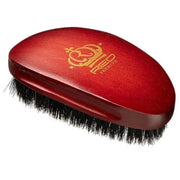 Red hairbrush with black bristles on a white background