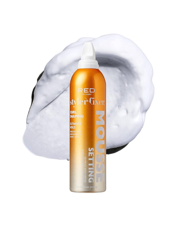 Orange hair product bottle with white foam on a white background