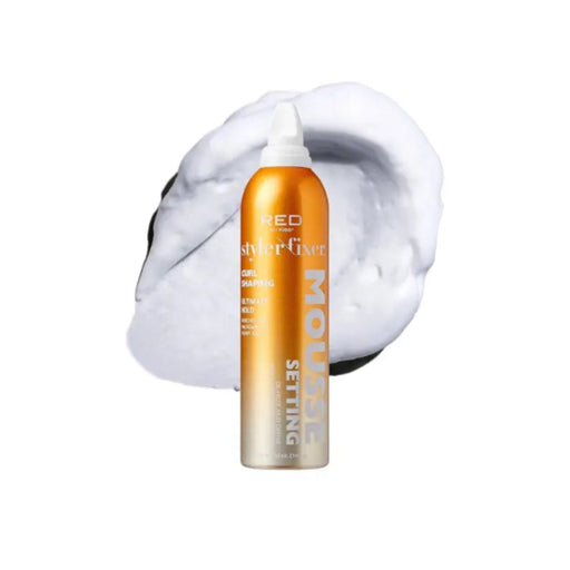 Orange bottle of Redken styling product with white foam on a white background