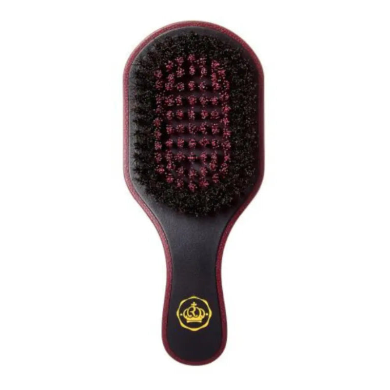A hairbrush with a dark reddish-brown handle and head, black bristles, and a gold crown logo near the base, shown against a plain white background.