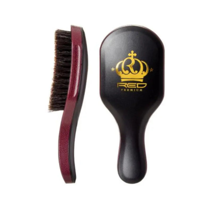 A hairbrush shown from two angles on a white background: one view shows the dark brown bristles with a burgundy handle, and the other shows the black oval head with a gold crown logo and the text 'RED PREMIUM'.