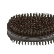 Close-up of a black oval hairbrush with dense dark bristles on a plain white background.