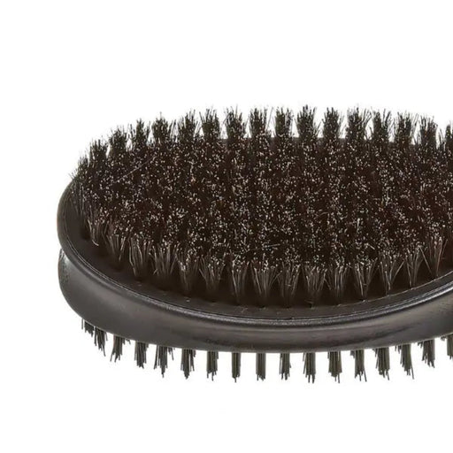 Close-up of a black oval hairbrush with dense dark bristles on a plain white background.
