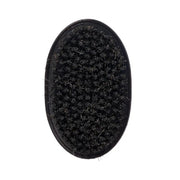 Black oval brush with bristles on a white background