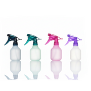 Four plastic spray bottles in white, mint green, pink, and clear with black, teal, magenta, and purple triggers, arranged in a row on a white background.